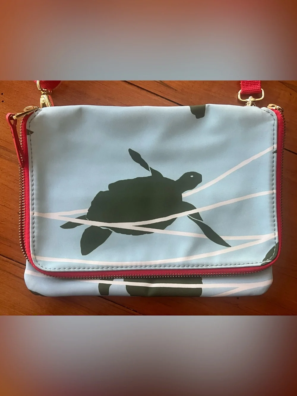 Fossil Light Blue Crossbody Bag with Dark Green Turtle Print and Orange Trim